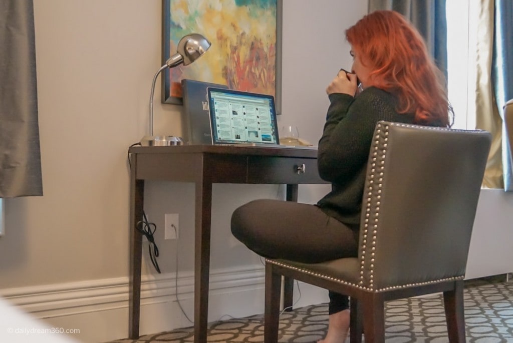 Sharon Mendelaoui sitting at desk drinking coffee at Idlewyld Inn London