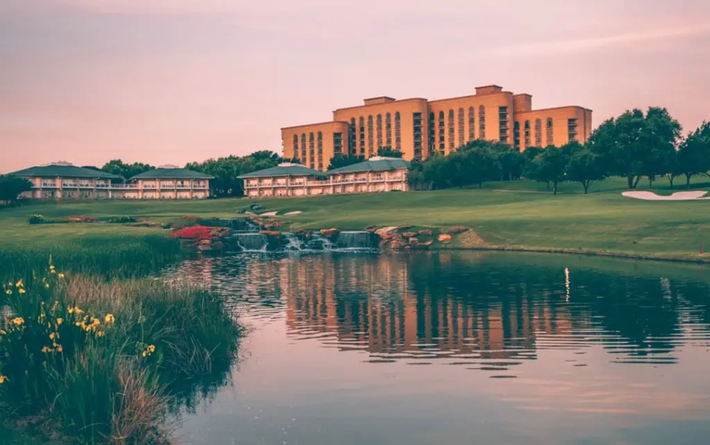 View from golf course over pond of Four Seasons Las Colinas Dallas building
