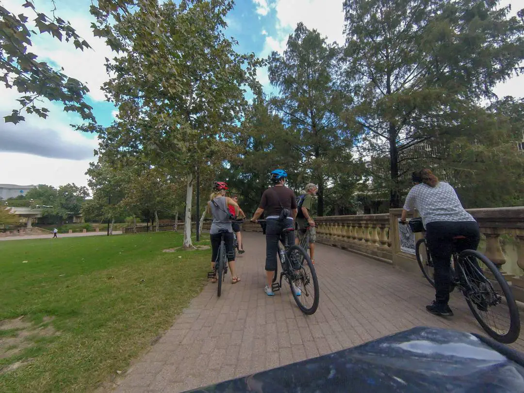 bike tour group riding through buffalo bayou park Houston bus tours and urban adventures
