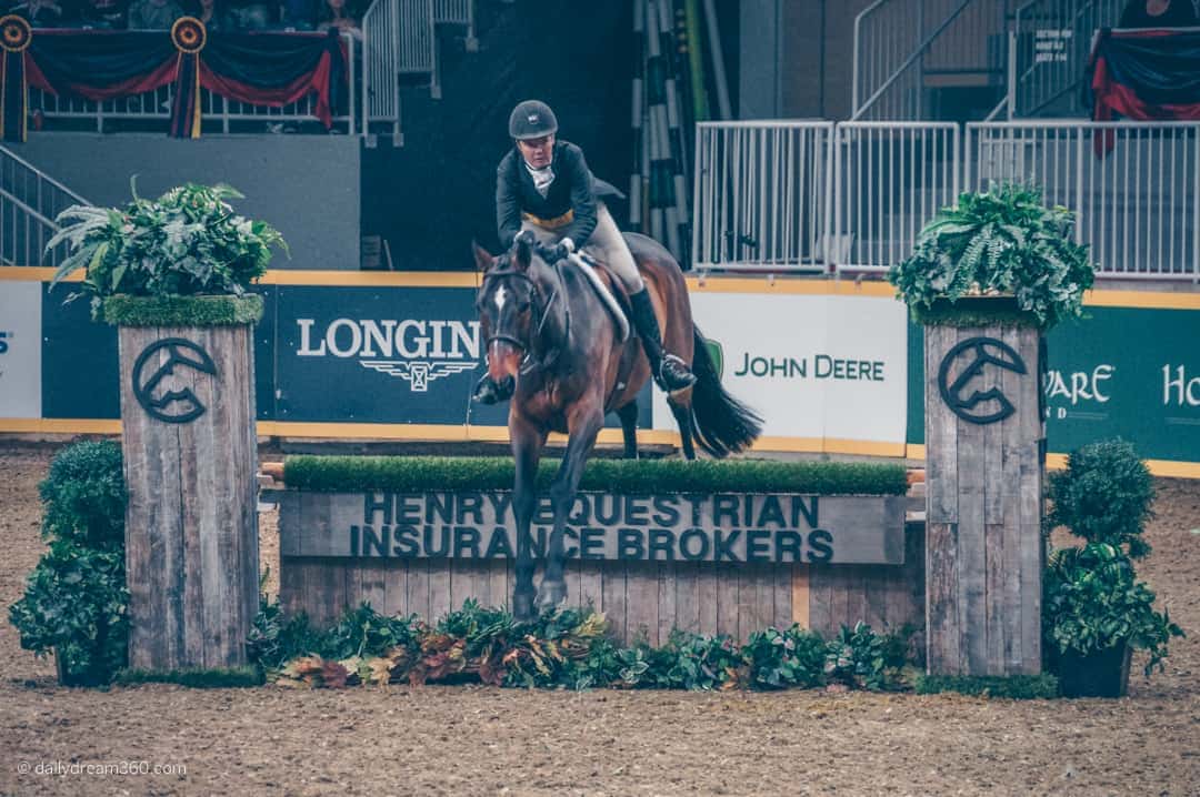 Horse jumps over obstacle at The Royal Agriculture Winter Fair Toronto