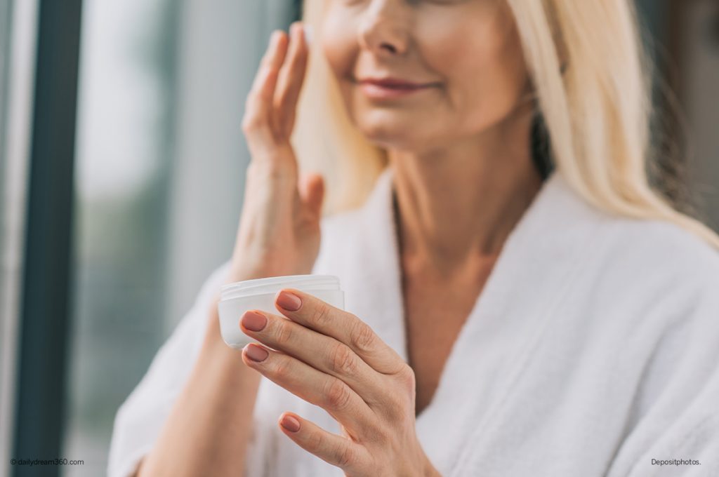 Mature woman applying face cream