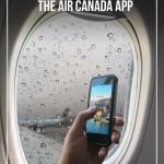 hand holding phone in airplane window covered with raindrops with blurred air canada plane in background of window