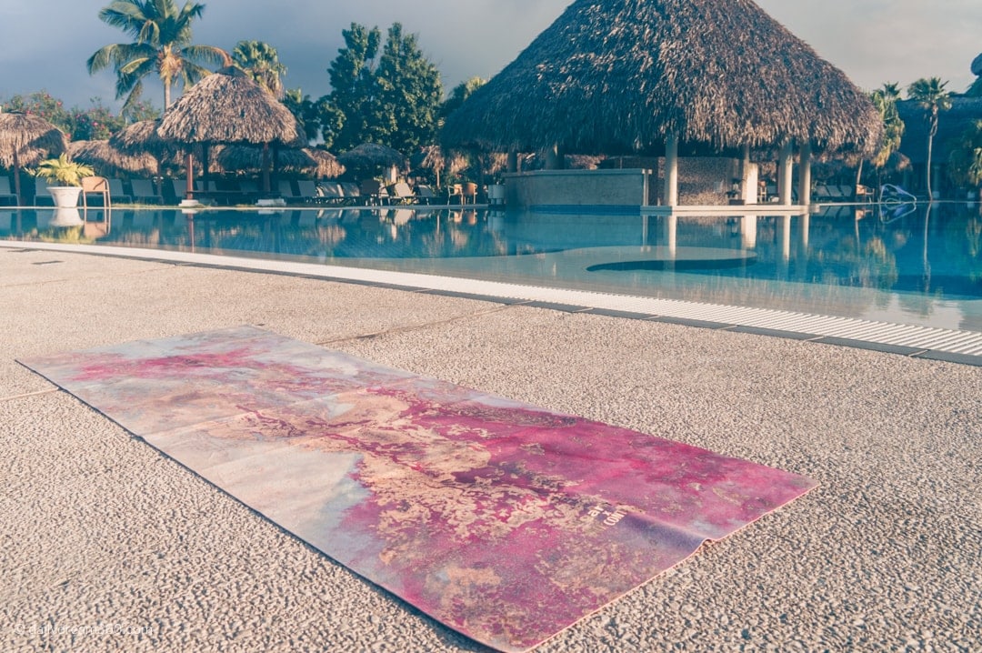 Sugarmat Travel Mat Dreamcatcher Red sitting beside pool in Cuba