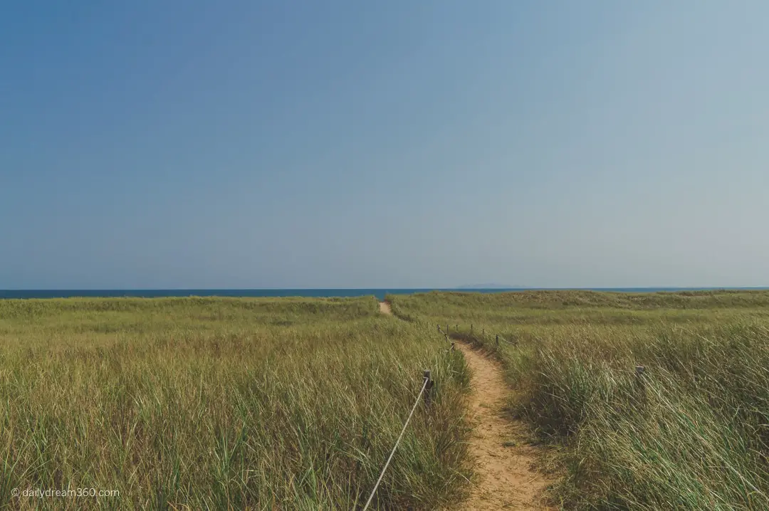 Long path, through grass to public beach on Havre Aubert Island Iles de la Madelaine Quebec