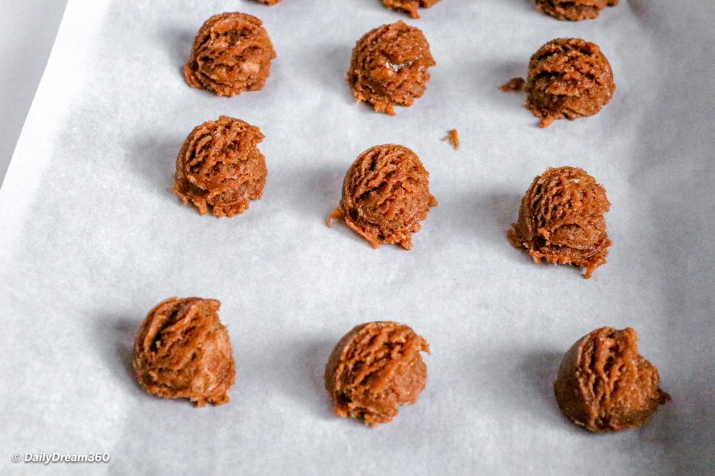 Keto Almond Butter Cookies with Chocolate Recipe mixing bowl with ingredients dough balls on baking sheet