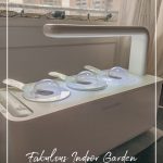 Click and Grow smart garden in windows with buildings behind and text: Fabulous Indoor Garden Ideas For Small Spaces and Condos