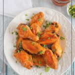 Keto wings on white plate with sauce and napkin and text: Low Carb Wing Sauce Keto Chicken Wings Recipe