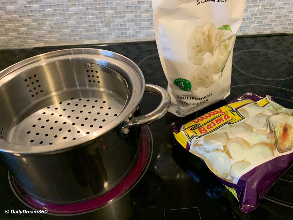 Bags of frozen vegetables and steamer pot