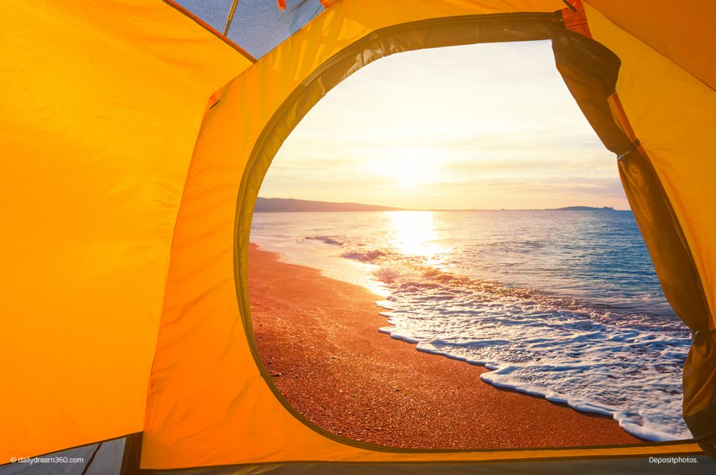 Look from inside beach shade to sunset over water