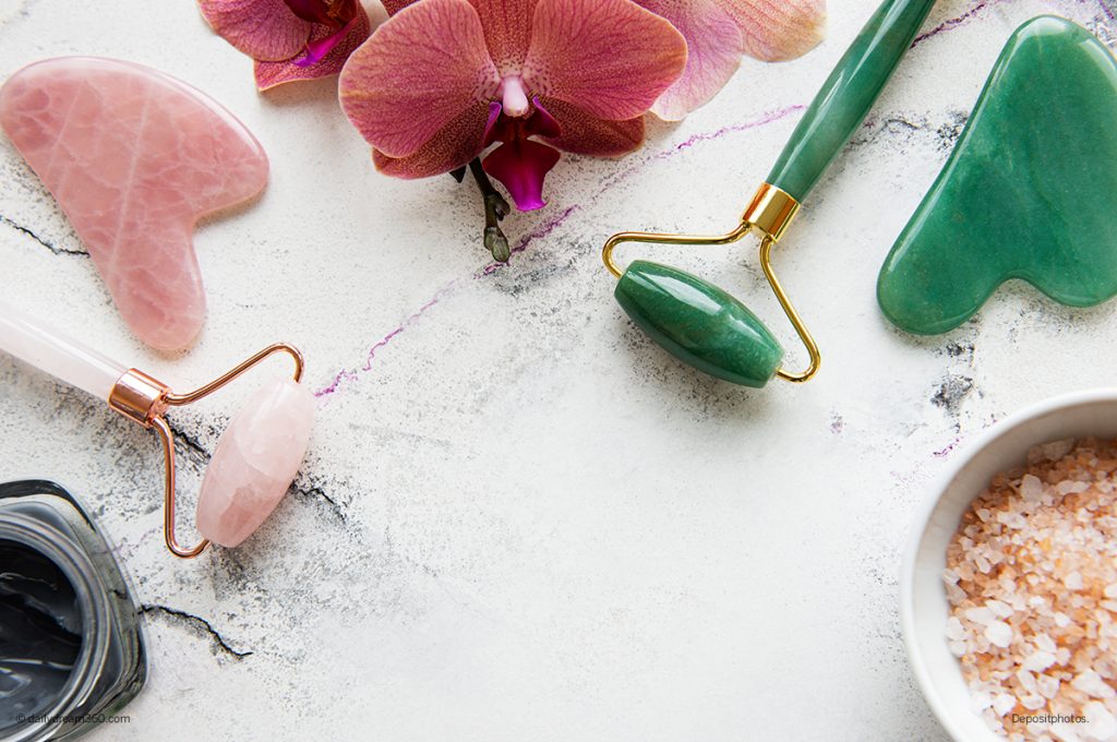 jade and quartz face roller on table