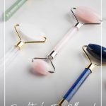 Various face rollers laid on table and text Benefits of a Face Roller and Which Crystal Roller Should You Choose?