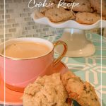 Pink coffee cup with cookies and tray of cookies in background with text Keto Low Carb Sugar Free Peanut Butter Chocolate Chip Cookies