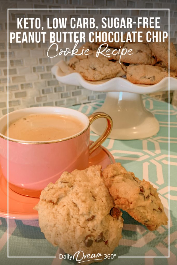 Pink coffee cup with cookies and tray of cookies in background with text Keto Low Carb Sugar Free Peanut Butter Chocolate Chip Cookies