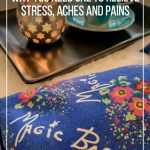 Magic Bag on blanket with candle and cup of tea and text: What is a Magic Bag? How to use it to Relieve Stress, Aches and Pains