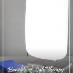 Light therapy lamp in front of books on a desk with text: Benefits of Light Therapy and the 5 Best Light Therapy Lamps