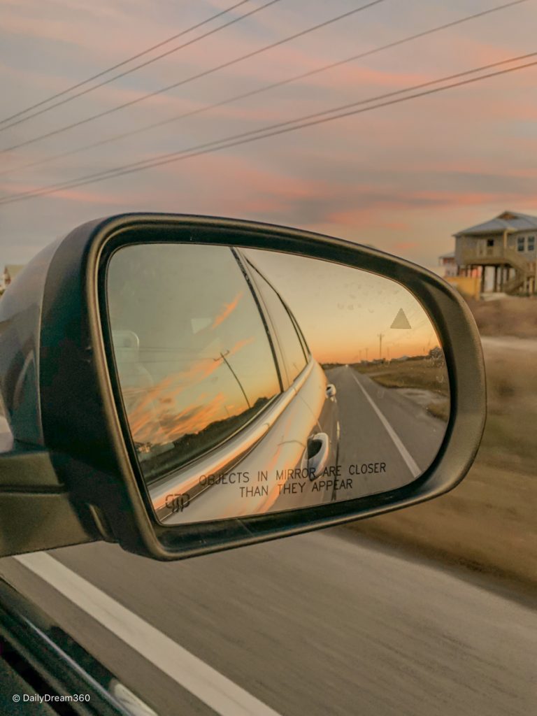 View of sunset in side mirror in Gulf Shores and Orange Beach