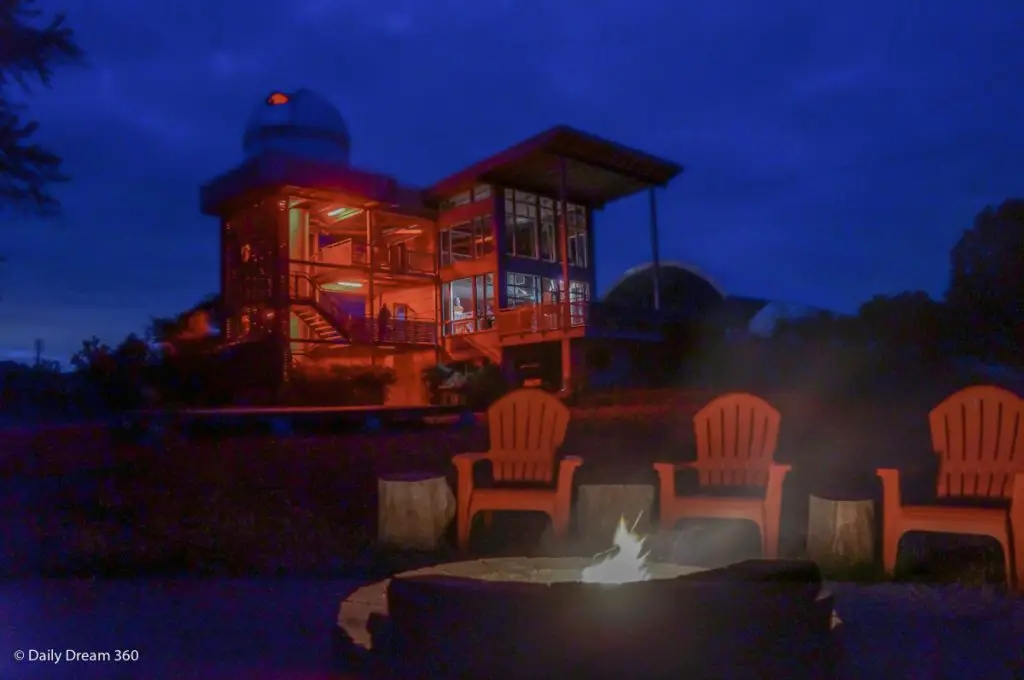 Observator at night with campfire in foreground at Long Point Eco-Adventures