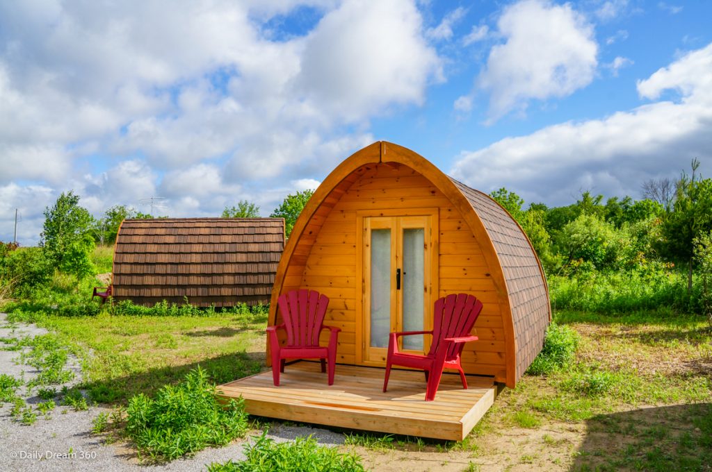 Wilderness Pod with two red chairs on deck at Long-Point-Eco-Adventures