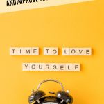 yellow background with alarm clock and letters spelling Time To Love Yourself. Pin Text: 3 Daily Habits to Change Your Life and Improve Your Success Mindset