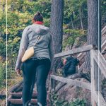 Woman walking up stairs on trail at Mont Tremblant Quebec with text: Exploring Fall Colours in Quebec and Best Things About Mont-Tremblant in Fall