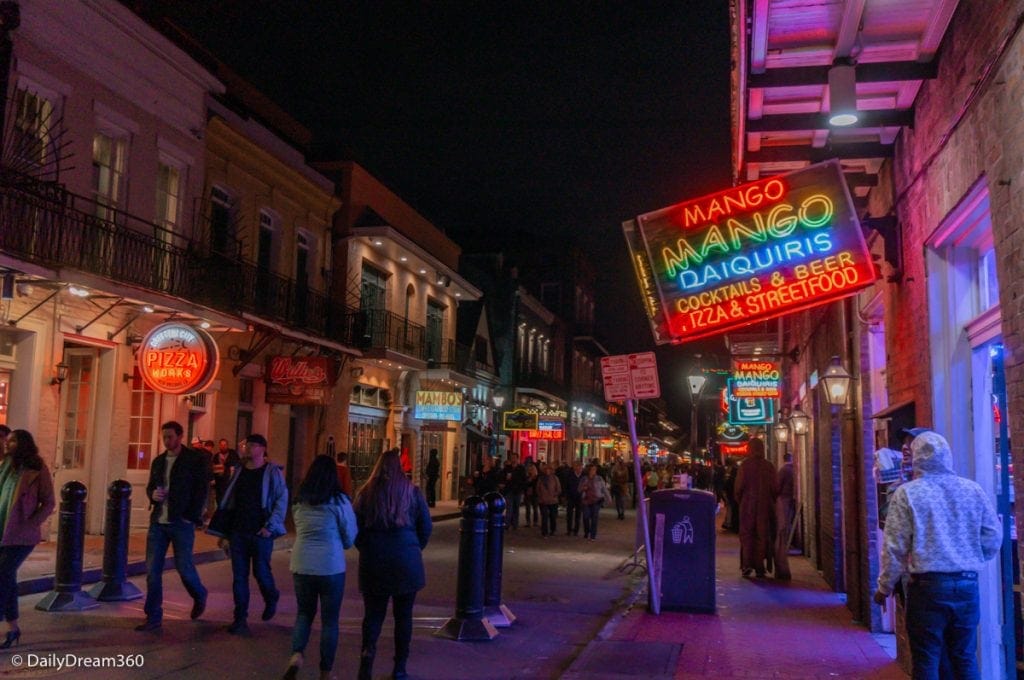 Bourbon Street at night with pedestrians walking in street New Orleans