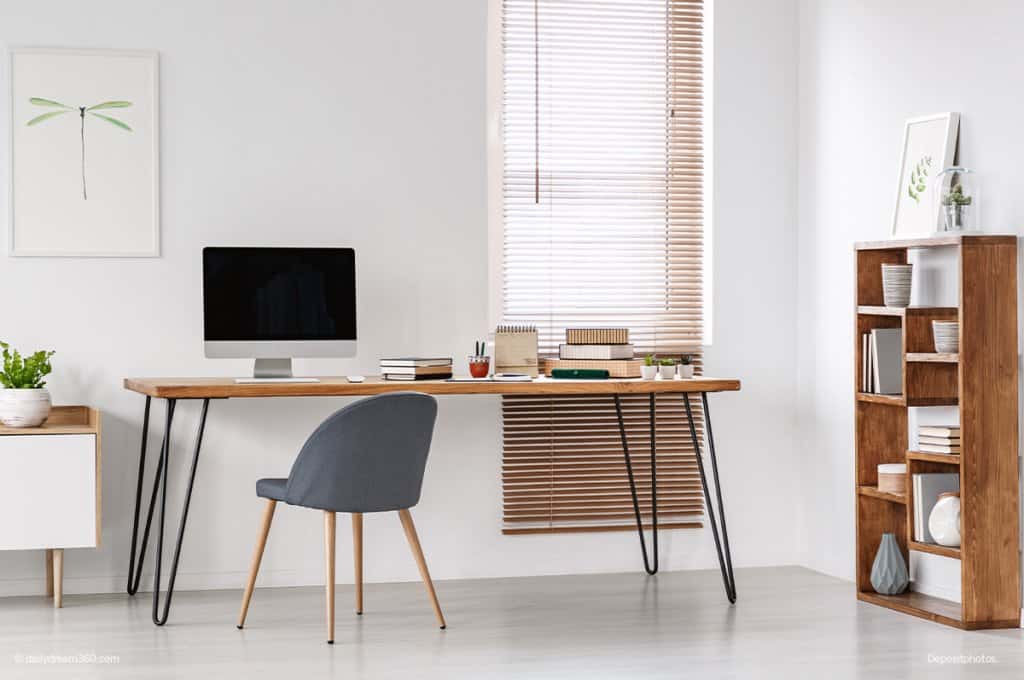 Clean desk with bookcase in home office