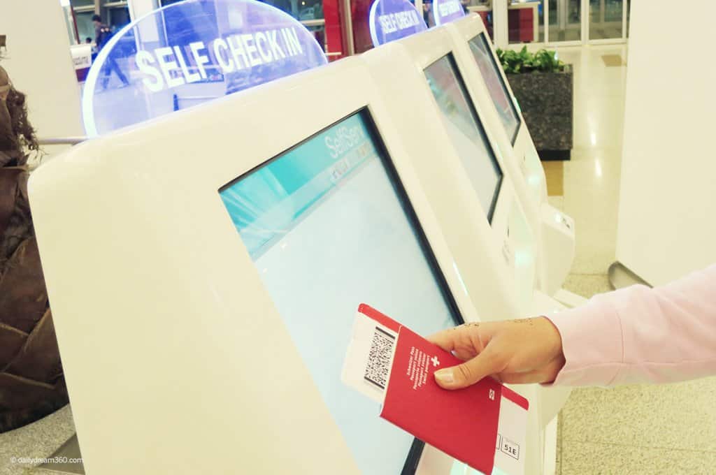 Person touching airport check-in machine