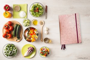 Clever Fox Food journal on table with meal prepped ingredients