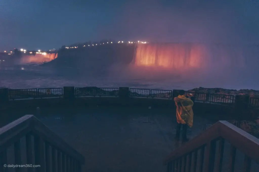 tourist taking photo on platform at Journey behind the falls attraction Niagara Falls