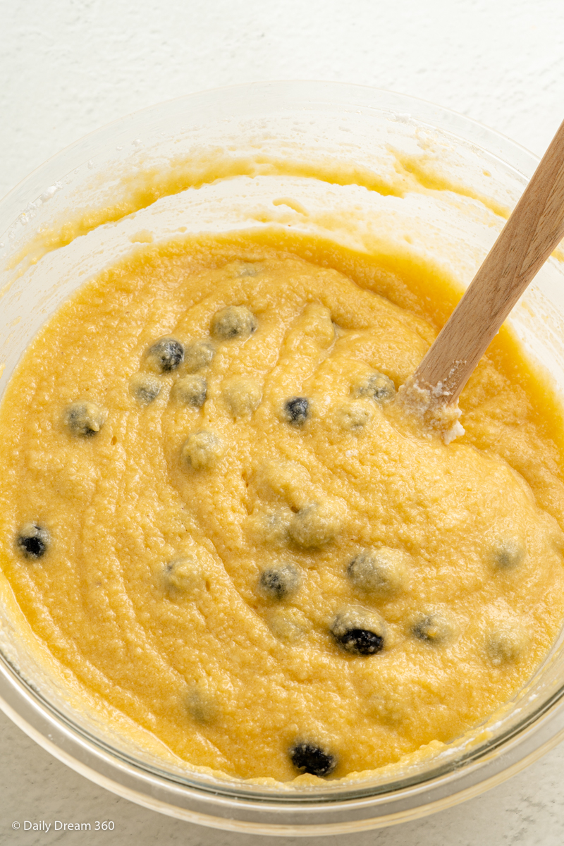 blueberries in bowl with mixture for keto blueberry lemon cake