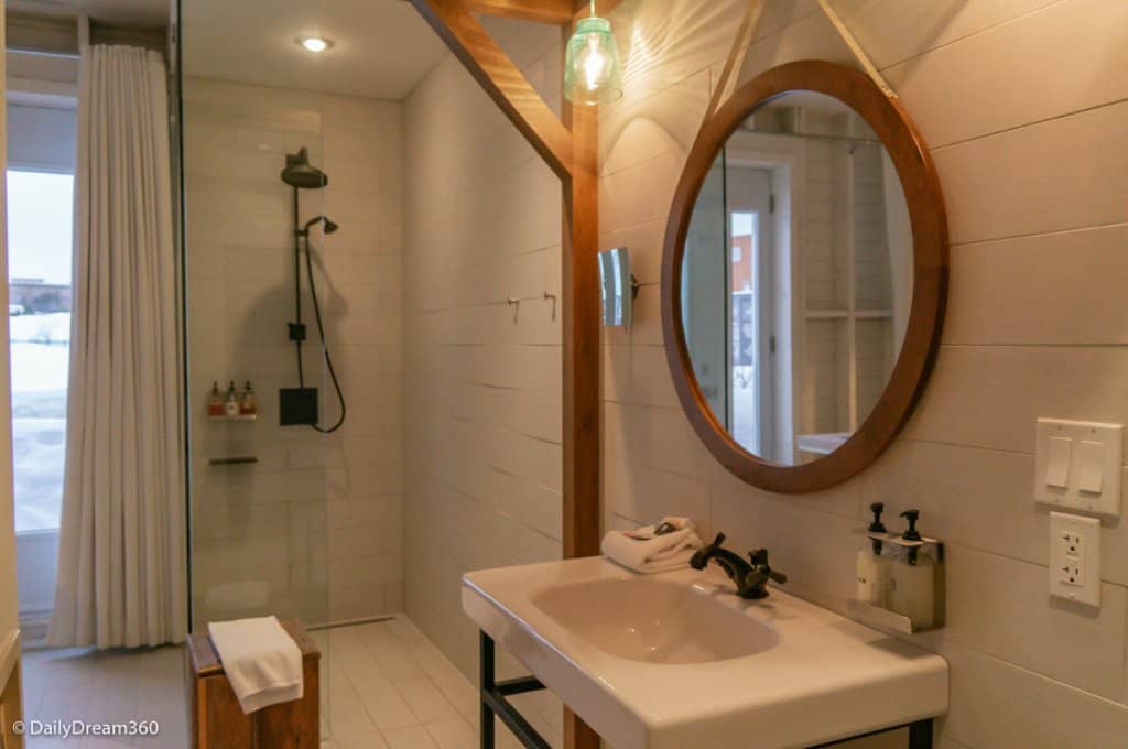 Bathroom area in Germain Charlevoix hotel room