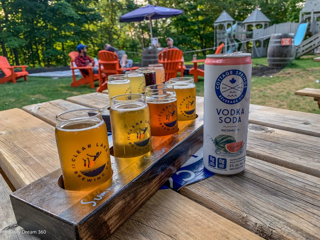 Beer flight and Vodka cooler on table in beer garden at Muskoka Beer Spa