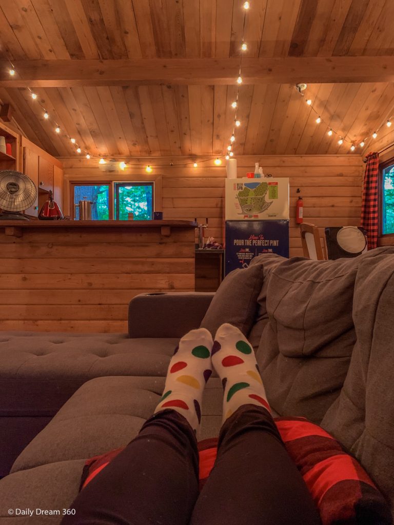 Woman sitting on couch looking into kitchen at Muskoka Beer Spa