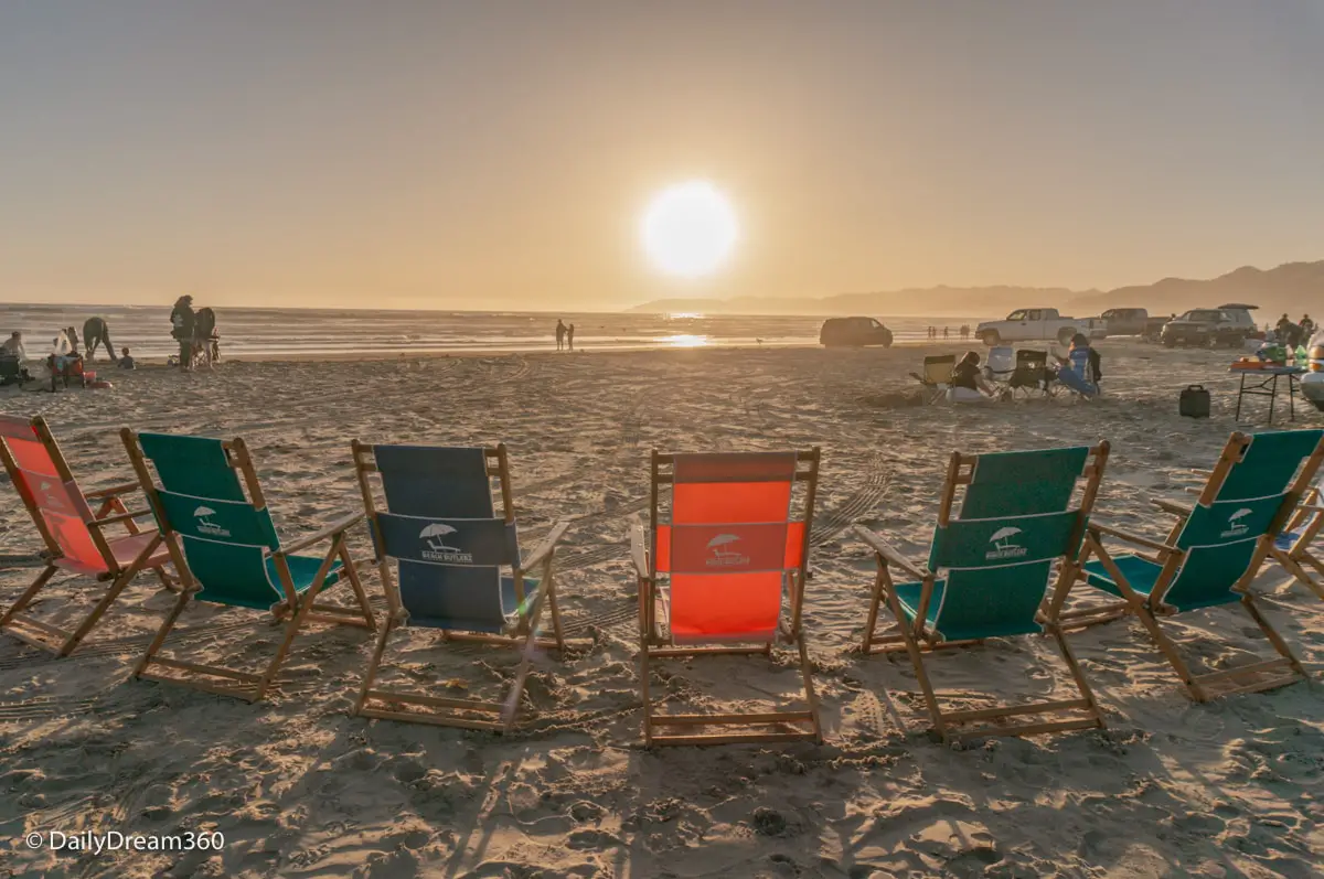 Beach chairs facing sunset at Oceano Dunes State Park