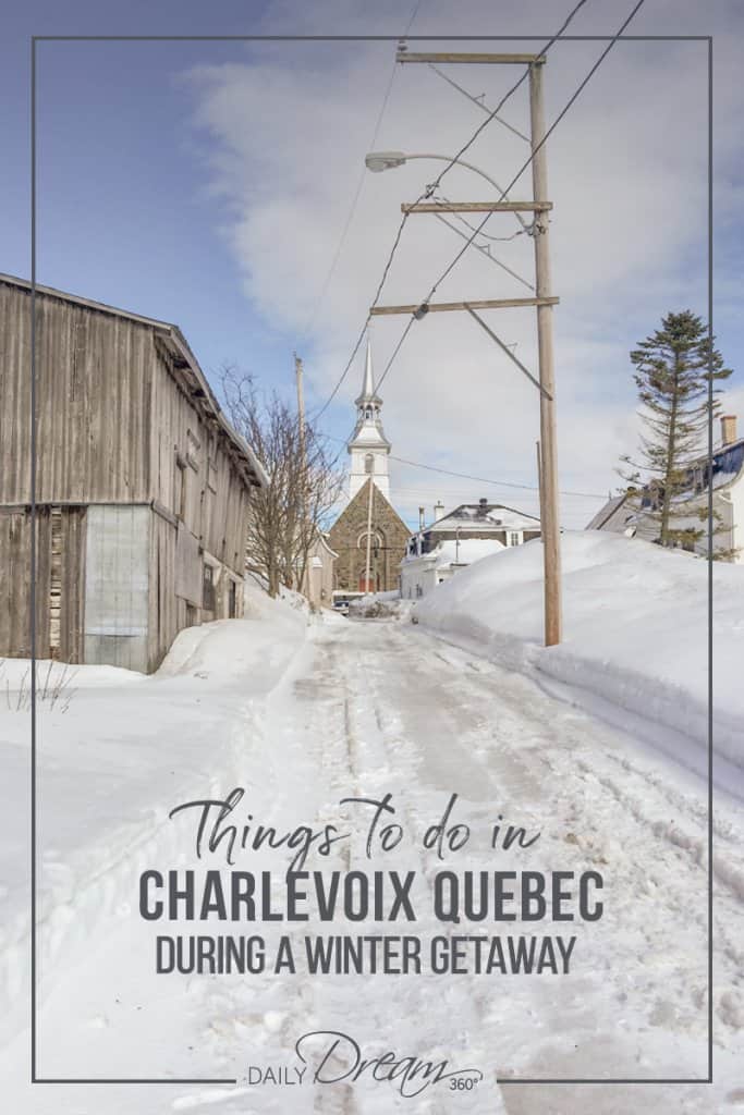 Church and wood buildings on a snowy road in Charlevoix Quebec