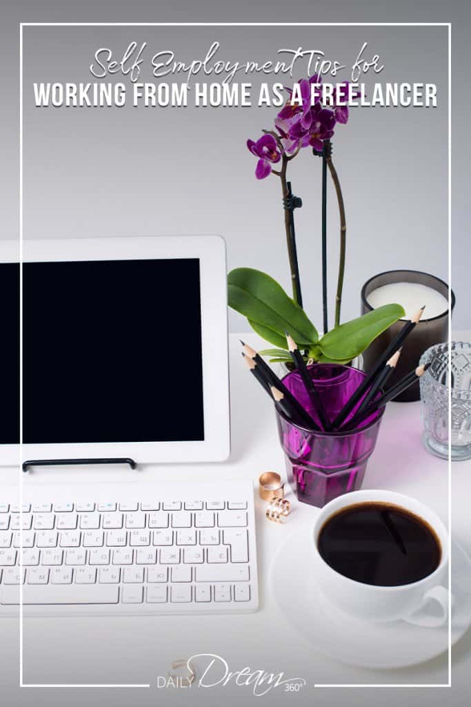 Computer on desk with keyboard and purple flower with text Tips for Working from Home as a Freelancer