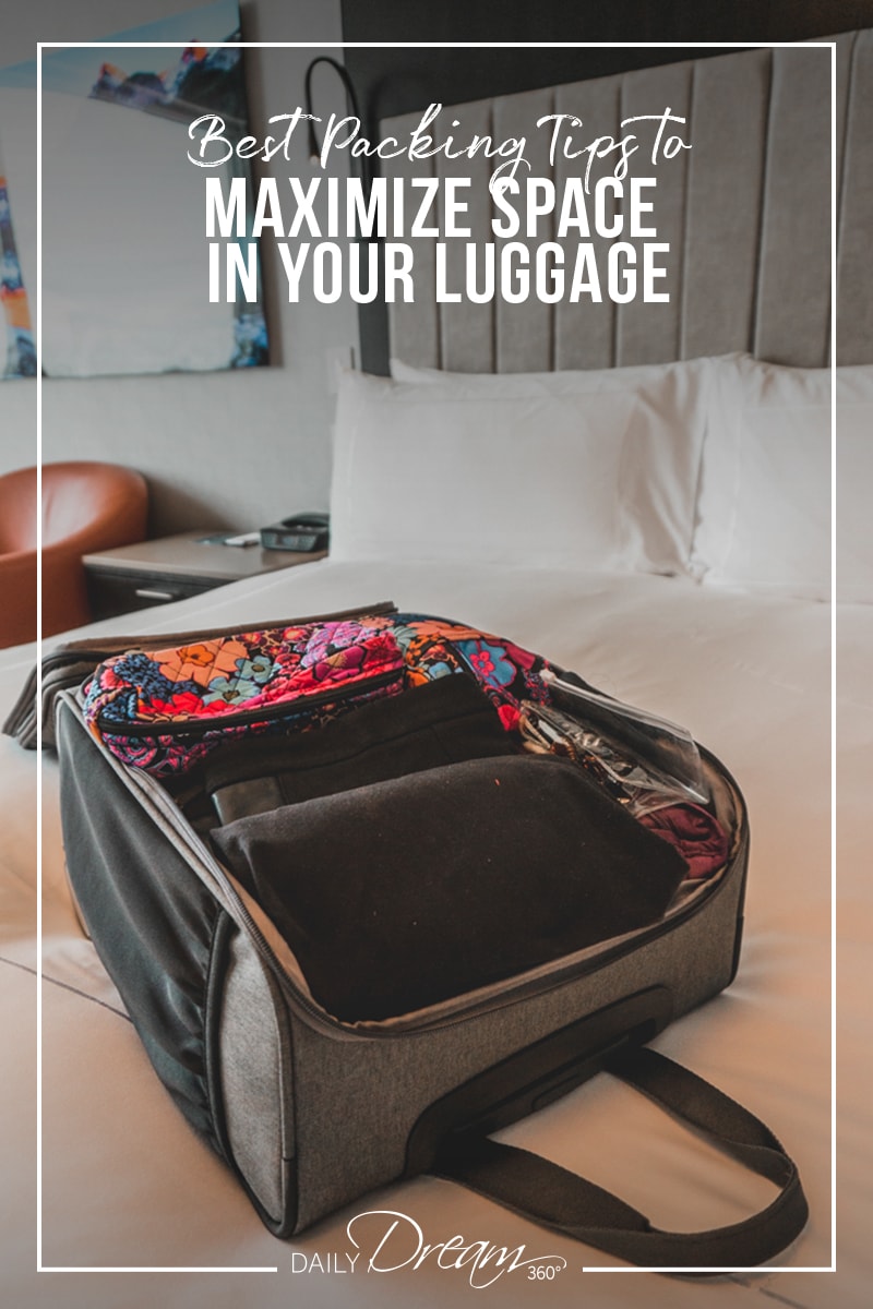 Small luggage open on hotel bed