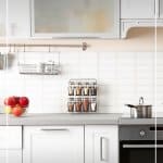 White kitchen with spice rack and text 7 Day Declutter Challenge: Day 6 Declutter Your Kitchen