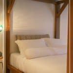 Wood frame bed in Germain Charlevoix Hotel