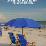 blue lounge chairs under blue umbrella at Sandpiper Gulf Resort Florida