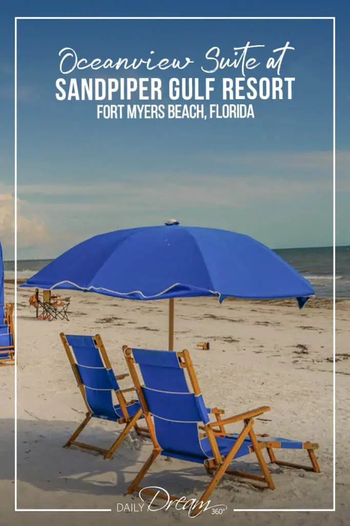 blue lounge chairs under blue umbrella at Sandpiper Gulf Resort Florida