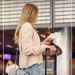 Girl checking ticket at airport text: Tips for Travelling During Cold and Flu Season