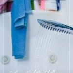 Shower caddy and shower head spraying water with text 7-Day Declutter Challenge: Day 4 Cleaning and Organizing Bathrooms