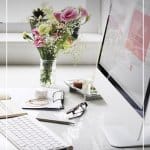 Feminine computer desk with pink flowers and text Tips for Working from Home as a Freelancer or Blogger