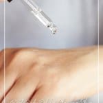 Woman dropping oil on arm with text Best Body Oil for Glowing Skin Body Oil Benefits