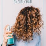 Girl with MoroccanOil products in her hands spraying curly hair