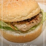 Turkey burger on white plate with text Recipe: Ground Turkey and Zucchini Burgers or Meatballs