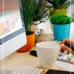 woman working on computer with coffee and text Tips for Working from Home as a Freelancer or Blogger