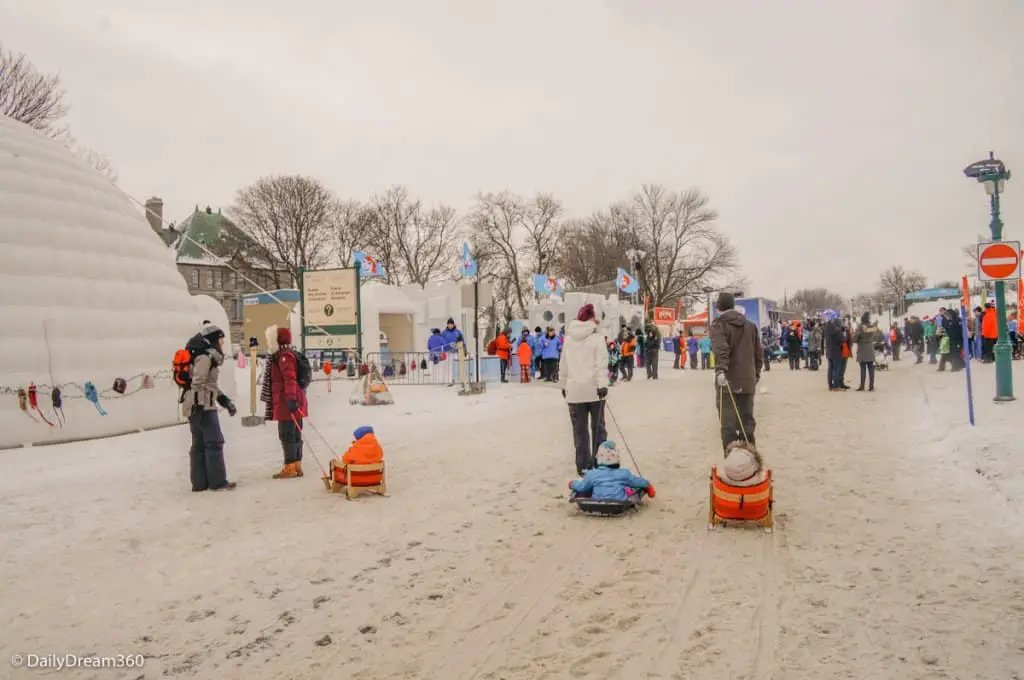 Families pull sleds through Quebec Winter Carnival