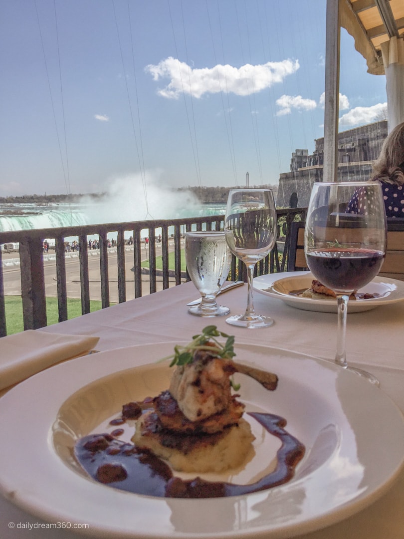 Meal on table overlooking horseshoe falls Queen Victoria Place Restaurant Niagara Falls